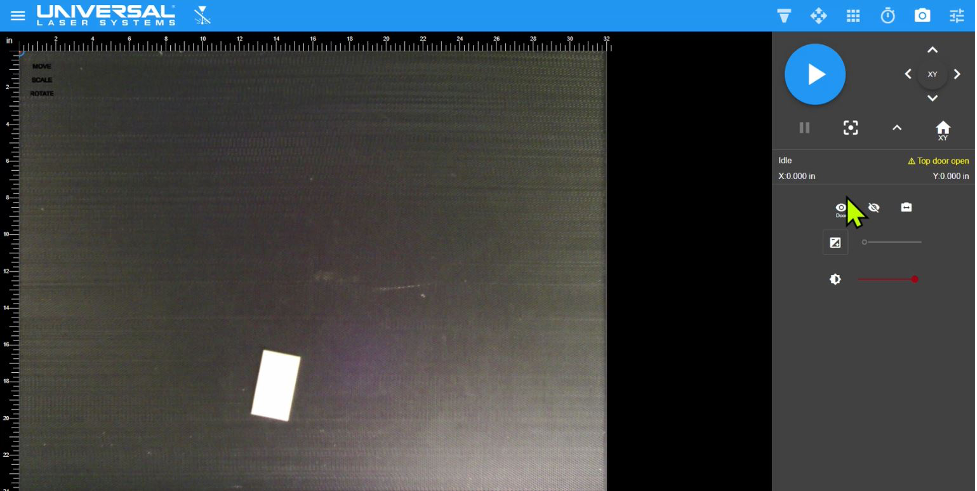 <i>Screen shot of entire material processing area as viewed in the Laser System Manager (LSM) captured by the top door camera. The entire 32 x 24 in. (831 x 610 mm) processing area of the ULTRA R5000 is visible along with an image of the 1.5 x 3 in. (38 x 76 mm) white plastic material placed on the Multifunction Material Support Structure.</i>
